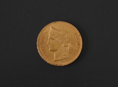 a close up of a gold coin on a black surface