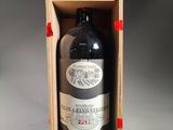 a bottle of wine in a wooden box on a table