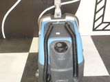 an image of a vacuum cleaner on a black and white checkered floor