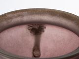 a bowl of water with a spoon sticking out of it