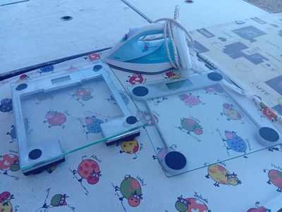 a table with a table cloth and an iron on it