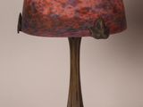 an image of a lamp with a red glass shade on it