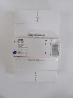 a white electrical device with a blue button on it