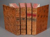 three old books sitting on top of each other on a table