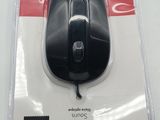 a black mouse in a package on a white table