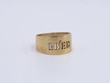 a close up of a gold ring with the word ' time ' engraved on it