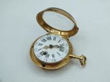 a gold pocket watch with roman numerals on it