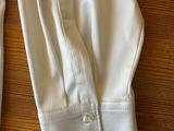 a pair of white pants sitting on a wooden table
