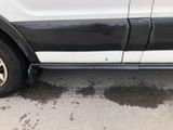 a white truck with a black stripe on the side of it