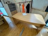a wooden desk with a mirror on it in a room