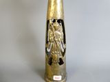 a gold vase with a statue of a man on it