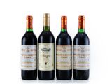 three bottles of wine are lined up on a white surface