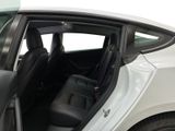 a white car with the door open and the driver ' s seat down