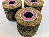 three wheel brushes are sitting on top of each other