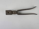 a small metal tool that is on a white surface