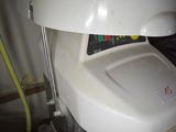 a white toilet that has a red sticker on it