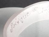 a close up of a toilet seat with a tag on it
