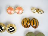many different types of jewelry on a white surface