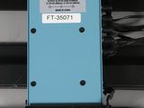 a close up of a blue electronic device on a black surface