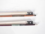 two different types of violin bows on a white surface