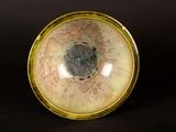 a close up picture of a bowl on a black surface