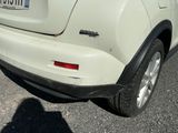 a small white car parked in a parking lot