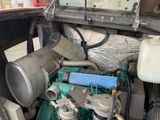 a truck that has a bunch of pipes in the back of it