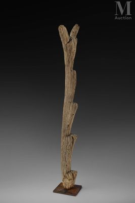 a wooden sculpture of a bird on a branch on a base