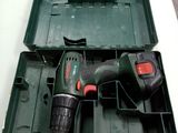 a cordless drill in a plastic case on a table