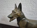 a statue of a dog that is sitting on a table