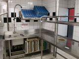 a stainless steel kitchen with a sink and dishwasher