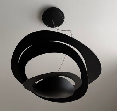 a black lamp hanging from the ceiling in a room