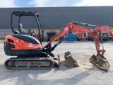 a small excavator that is parked in the parking lot