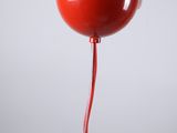 a person holding a red bowl with a spoon in it