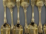 six spoons that are hanging on a wall