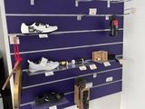 a purple wall with a bunch of shoes on it