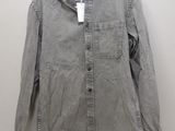 an image of a gray shirt hanging on a hanger