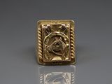 a close up of a gold ring with a horse on it