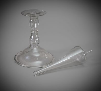 two empty wine glasses sitting next to each other on a table