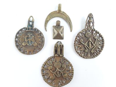 four antique silver metal pendants with a crescent and a crescent