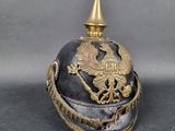 un vieux casque orné d'un aigle royal sur fond gris