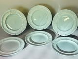 several plates and bowls are lined up on a table
