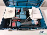 a blue tool box with tools in it on a table