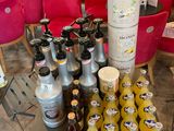 many bottles of juice on a table in a store