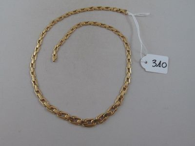 a close up of a gold chain on a white surface