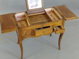 a small wooden table with a mirror on top of it
