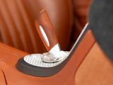 a close up of a car ' s leather seat with a button on it