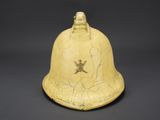 an old yellow helmet with a skull and cross on it
