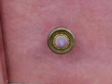 a close up of a pink cabinet with a gold knob