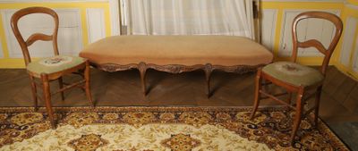 three chairs and a table in the corner of a room